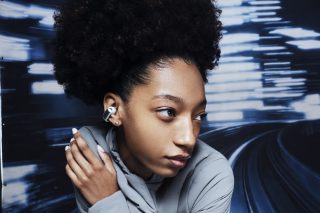 Woman wearing Bose Ultra Open Earbuds