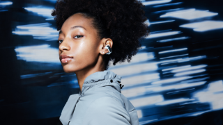 Woman wearing Bose Ultra Open Earbuds