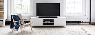 TV and Bose soundbar on a TV stand