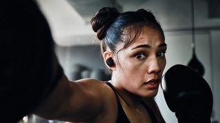 Janay Harding wearing Bose Sport Earbuds while training