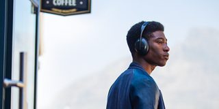 Man wearing Black Bose Noise Cancelling Headphones 700