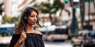 Woman wearing Black Bose Noise Cancelling Headphones 700