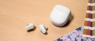 Bose QuietComfort Earbuds II and their charging case on a table