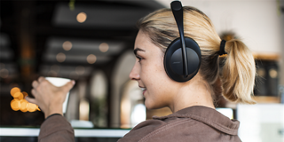 Woman wearing Bose Noise Cancelling headphones 700