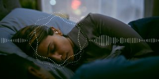 Woman sleeping with Bose noise-masking sleepbuds