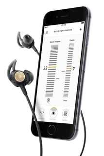 Hearphones with a smartphone displaying the World Volume and Treble levels of the Bose Hear app