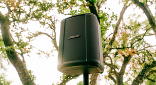 Système de sonorisation sans fil Bose S1 Pro+ monté sur un support d’enceinte en extérieur