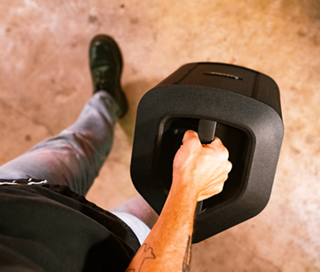 Musician carrying the S1 Pro+ Wireless PA System with the built-in carry handle