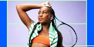 Coco Gauff holding a tennis racket and wearing Bose Ultra Open Earbuds