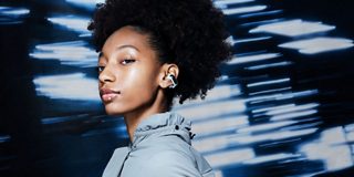 Woman wearing Bose Ultra Open Earbuds
