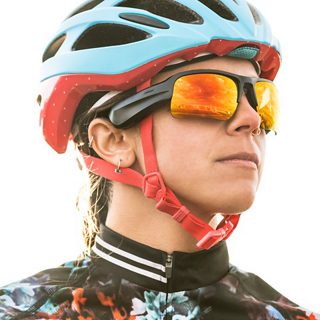 Woman biker wearing Bose Frames Tempo with Road Orange lenses