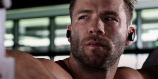 Athlete working out while wearing Bose Sport Earbuds