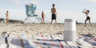 SoundLink Revolve Bluetooth speaker on a blanket at the beach
