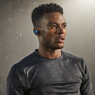 Man wearing SoundSport Free wireless headphones in the rain