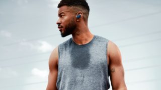 Man wearing Baltic Blue Bose Sport Earbuds while working out