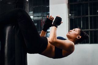 Janay Harding wearing Bose Sport Earbuds while training