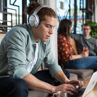 Person listening to music using QuietComfort 35 headphones