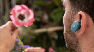 Man wearing Stone Blue Bose QuietComfort Earbuds