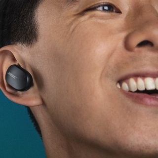 Man wearing Triple Black Bose QuietComfort Earbuds