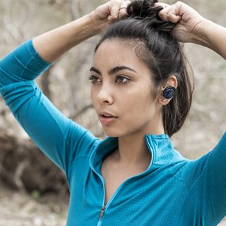 Woman wearing Midnight Blue SoundSport Free wireless headphones