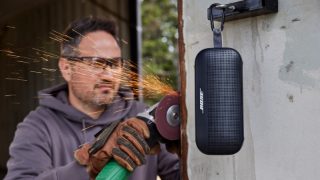 SoundLink Flex Bluetooth speaker hanging from its utility loop outside