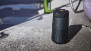 SoundLink Revolve II Bluetooth speaker outside near an inflatable pool