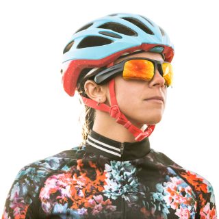 Woman biker wearing Bose Frames Tempo with Road Orange Lenses