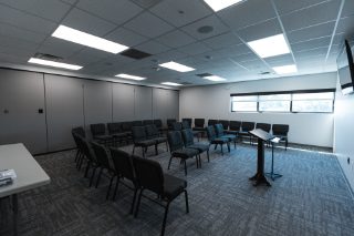 Breakout Room with desks and podium.