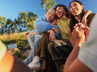 Young people outside listening to a Bose SoundLink Max Portable Speaker