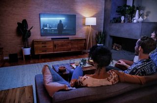 Couple watching TV in a living room with a Bose Smart Soundbar 600
